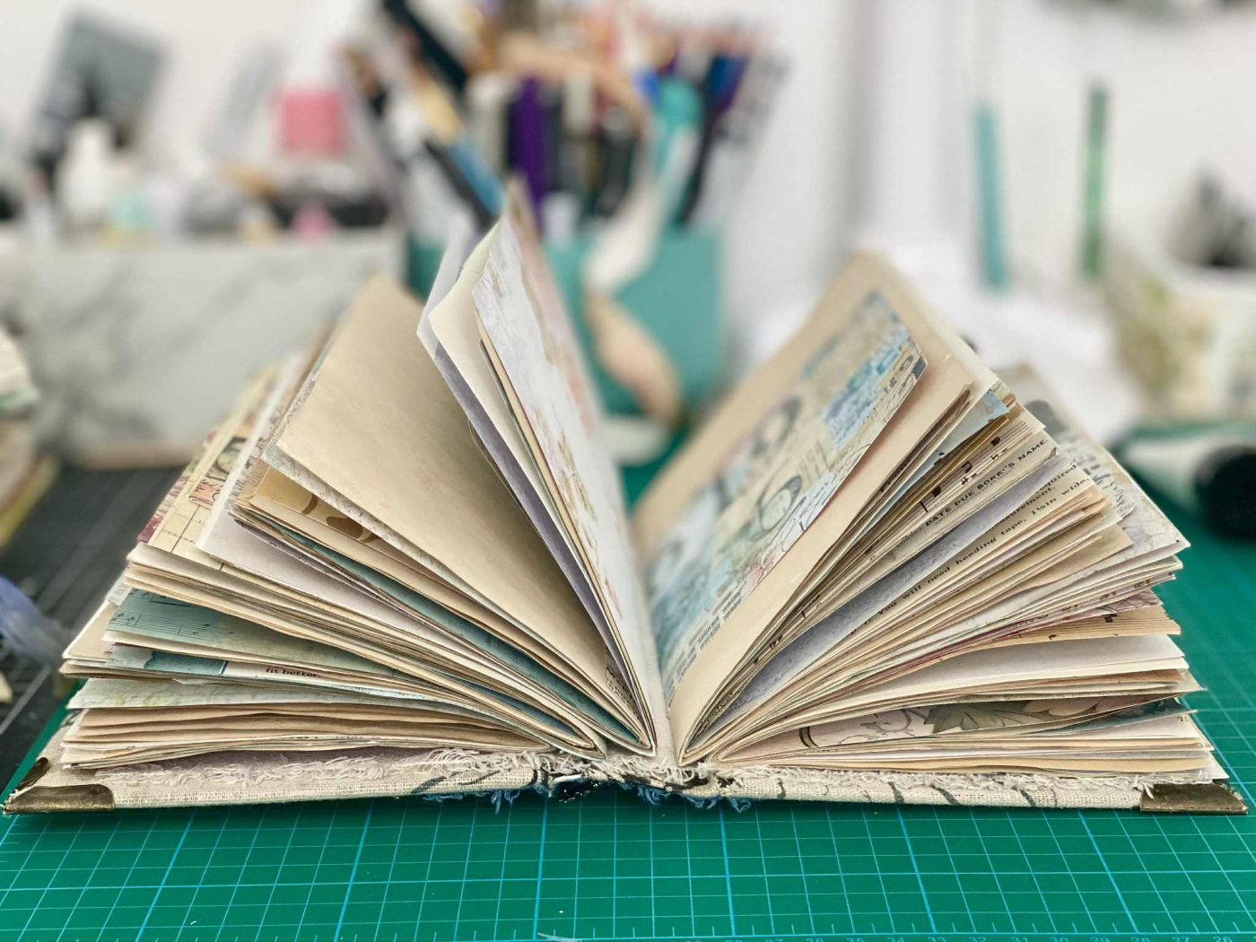 mixed media book with printed and coffee dyed papers