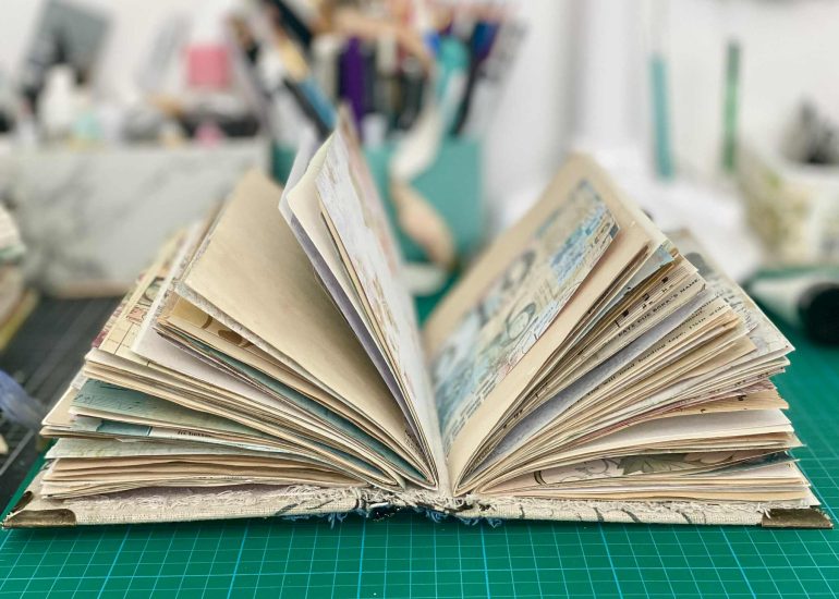 mixed media book with printed and coffee dyed papers